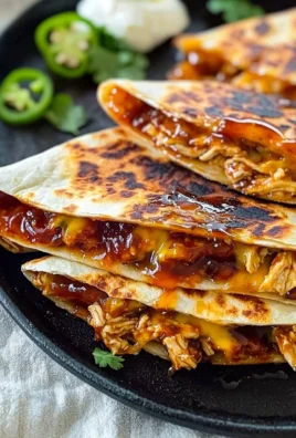 Blackstone Hot Honey BBQ Chicken Quesadillas with melted cheese and toppings.