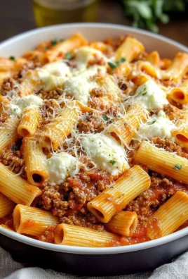 Cheesy baked rigatoni with ground beef topped with melted cheese and herbs