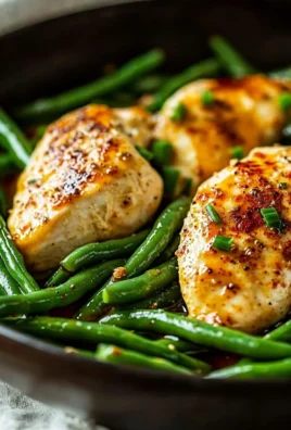Healthy chicken breast served with fresh green beans on a plate