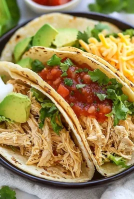 Delicious crockpot chicken tacos topped with fresh ingredients