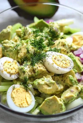 Bowl of herby avocado egg salad with fresh ingredients, ready for a quick lunch