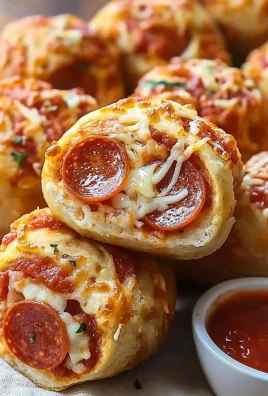 High protein pepperoni pizza rolls served on a plate with dipping sauce