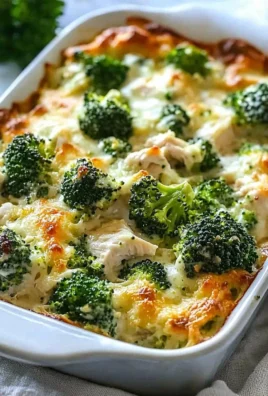 Keto Chicken Alfredo Broccoli Bake topped with cheese and herbs