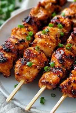 Delicious Korean chicken skewers with marinated chicken and vegetables on sticks.