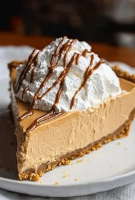 Delicious no bake peanut butter pie garnished with chocolate and peanuts.