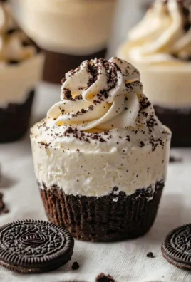 Oreo no-bake cheesecake cups topped with chocolate and cookie crumbs