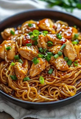 Sticky Garlic Chicken Noodles served in a bowl with fresh herbs