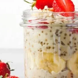 Bowl of colorful overnight oats topped with fruits and nuts
