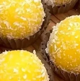 3-Ingredient Mango Delight Truffles on a plate, garnished with mango slices.