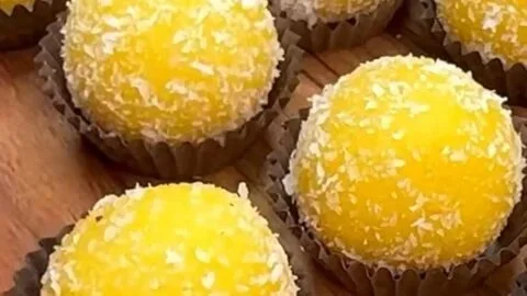 3-Ingredient Mango Delight Truffles on a plate, garnished with mango slices.