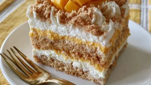 Delicious no-bake mango float dessert with layers of cream and mango slices.