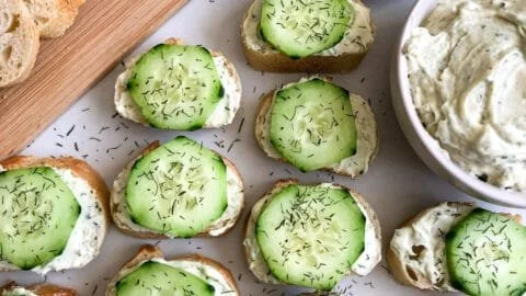 Cucumber Cream Cheese Bites with Mini Baguettes on a serving platter