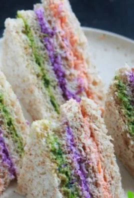 Easy colorful tea sandwiches arranged on a platter for an afternoon tea.