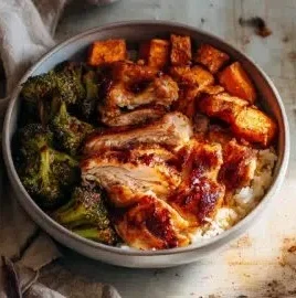 Delicious hot honey chicken rice bowls topped with fresh vegetables and sauce
