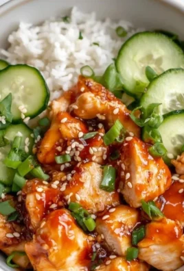 Hot honey chicken bowls served with rice and cucumber in a vibrant dish