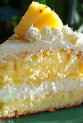 A luscious slice of Pineapple Heaven Cake garnished with fresh pineapple.
