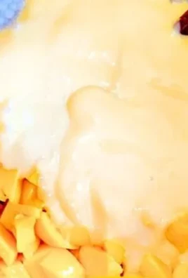 Delicious Mango Bango dessert topped with fresh mango slices and whipped cream