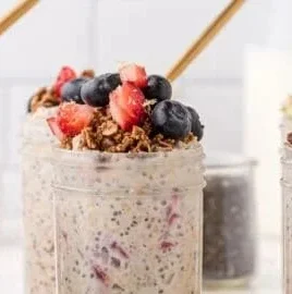 Bowl of overnight chia oats topped with fresh fruits and nuts.
