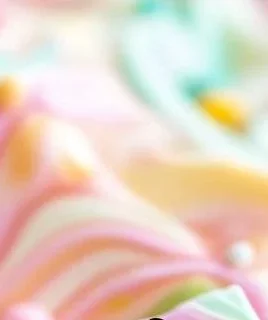 Pastel-colored frozen yogurt bark topped with fruits and nuts