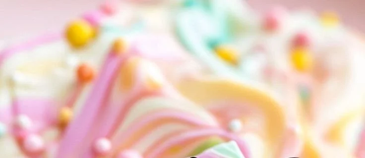 Pastel-colored frozen yogurt bark topped with fruits and nuts