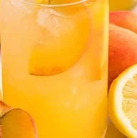 A refreshing glass of peach lemonade with slices of peach