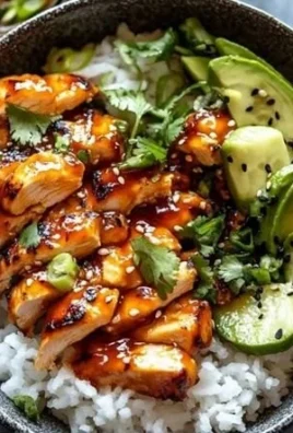 Spicy honey-ginger chicken bowls served with fresh vegetables and rice