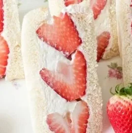 Delicious strawberry cream sandwiches served on a plate.