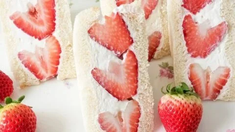 Delicious strawberry cream sandwiches served on a plate.