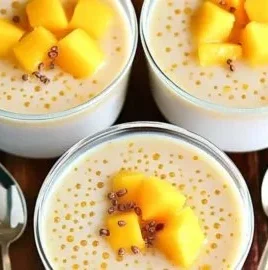 Delicious bowl of Tropical Mango Sago dessert with coconut milk and fresh mango cubes.