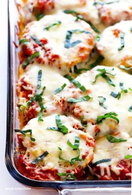 Baked Eggplant Parmesan topped with fresh basil and melted cheese