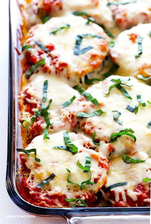 Baked Eggplant Parmesan topped with fresh basil and melted cheese