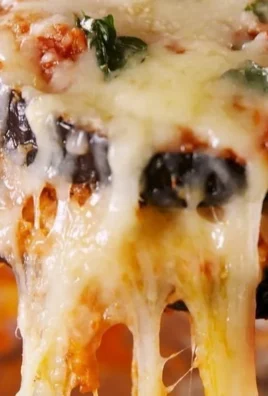 Deliciously baked eggplant parmesan with layers of cheesy goodness and marinara sauce