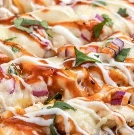BBQ Ranch Chicken Flatbread topped with fresh ingredients and drizzled with ranch sauce