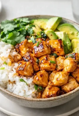 Delicious hot honey chicken bowl with vibrant vegetables and rice