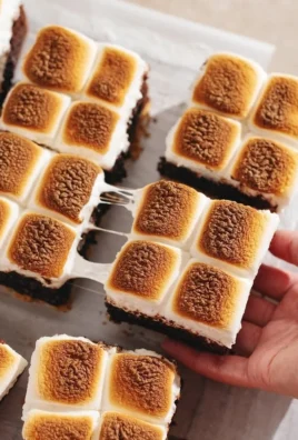 Decadent s'mores brownies with chocolate, graham crackers, and marshmallows