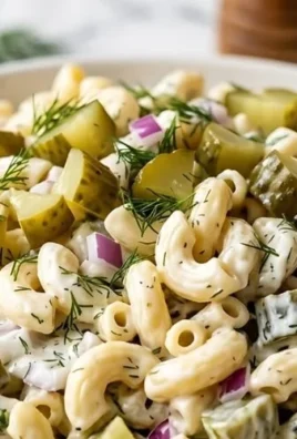 Delicious Dill Pickle Pasta Salad served in a bowl with herbs