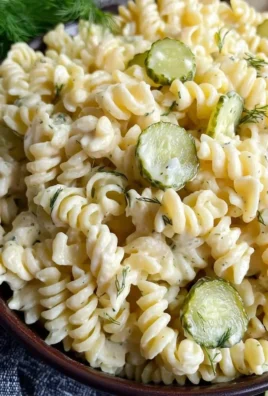 Delicious Dill Pickle Pasta Salad served in a bowl with fresh ingredients.