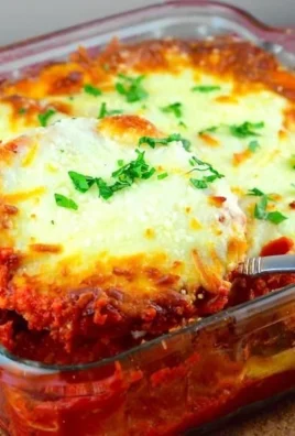 Easy eggplant parmesan dish with cheese and fresh herbs on a plate