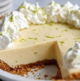 Delicious gluten free key lime pie topped with whipped cream and lime slices
