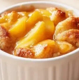Delicious easy peach cobbler fresh out of the oven, served in a bowl.