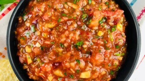 Fresh jalapeno peach salsa served in a bowl, showcasing vibrant colors and textures.