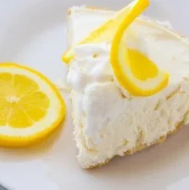 Delicious Frozen Lemonade Pie served with lemon slices and whipped cream.