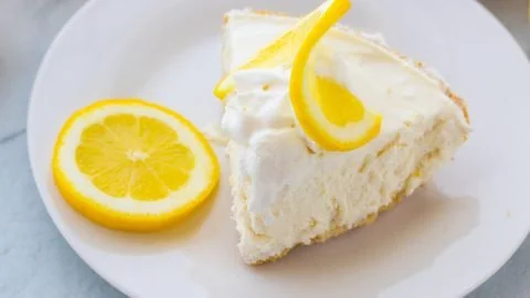 Delicious Frozen Lemonade Pie served with lemon slices and whipped cream.