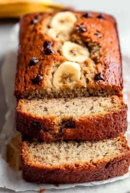 Slice of Greek Yogurt Banana Bread on a plate with bananas