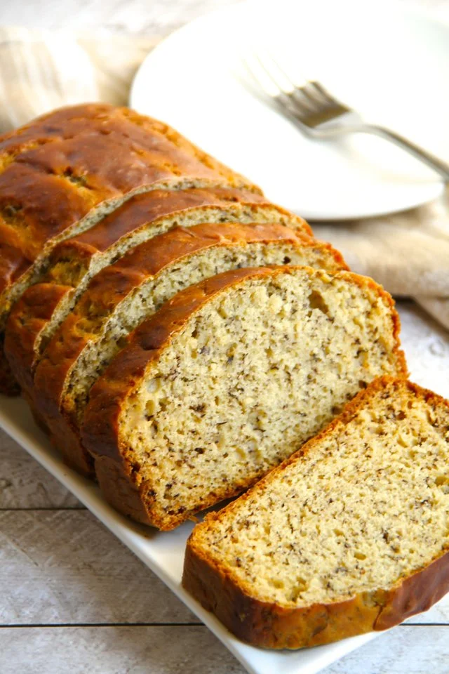Slice of Greek Yogurt Banana Bread on a wooden table