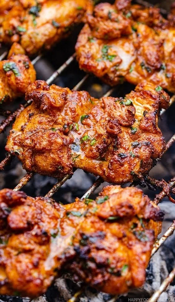 Delicious grilled boneless chicken thighs on the barbecue grill.