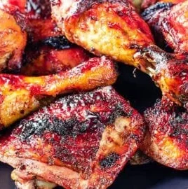 Delicious grilled chicken thighs and legs on a BBQ grill