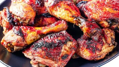 Delicious grilled chicken thighs and legs on a BBQ grill