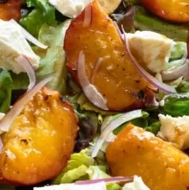 Delicious grilled peach salad with fresh greens and creamy cheese