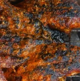 Juicy Grilled Piri Piri Chicken garnished with fresh herbs